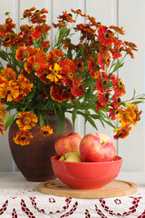Still life composition with helenium flowers and fresh apples