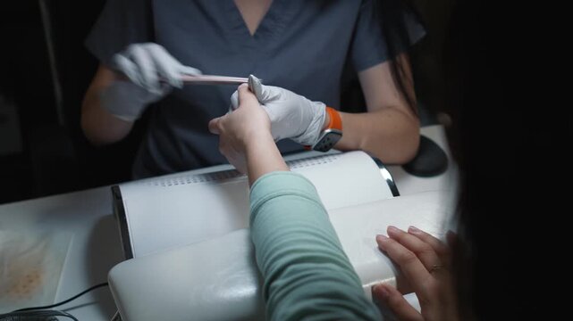 Nail filing and shape correction during preparation for manicure procedure
