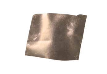 Crumpled metallic foil sheet with soft gold and champagne tones, abstract reflective surface.