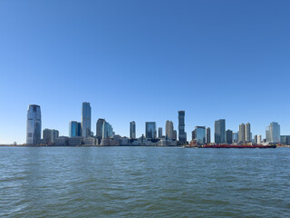 Obraz premium Jersey City Waterfront Skyline with Modern High-Rise Buildings on a Clear Day