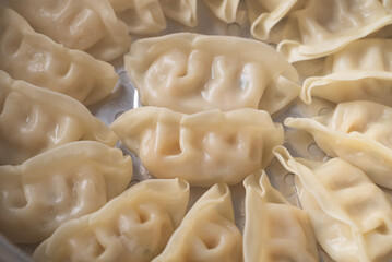 Close up of hot steamed dumplings in a steamer pot