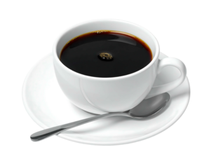 White ceramic cup overflowing with dark, hot coffee on a matching saucer with spoon