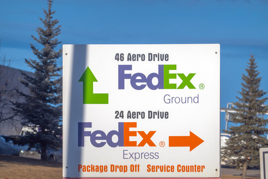 Calgary, Alberta, Canada. Jan 19, 2026. A FedEx Ground and Express directional sign at a shipping facility entrance.
