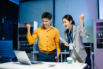 Asian business colleagues celebrating success in modern office, teamwork achievement, startup growth, motivation