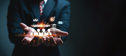 A businessman holding icons of men on hands, skill up concept professional in a suit presents a glowing, featuring the text SKILL UP and various icons representing employees, goals, and growth.