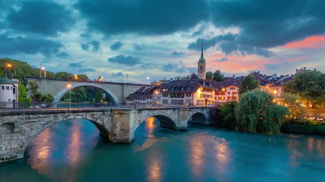 Bern, Switzerland. View of stone Untertorbrucke (Lower Gate) bridge and Aare river at dusk (static image with animated sky and water)