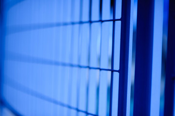 Futuristic abstract background featuring blue sky reflections on glass and steel architecture with...