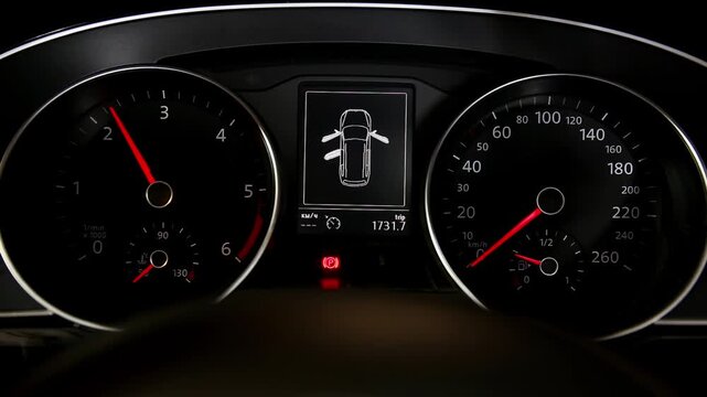 Illuminated car dashboard shows speedometer, tachometer, digital display with open car doors warning, parking brake engaged, and current trip mileage.
