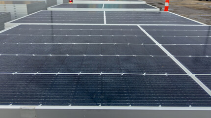 Close-up low-angle view of photovoltaic solar panels, highlighting sustainable energy technology and renewable power infrastructure.