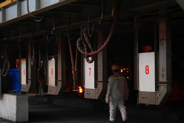 Workers working at high temperatures in the steel rolling workshop