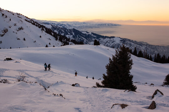 Hikers in the snowy mountains above Almaty, Kazakhstan