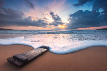 Beautiful sunrise over the sea wave and beach shore