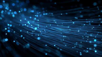 A close-up view of a bundle of glowing blue fiber optic cables against a dark background