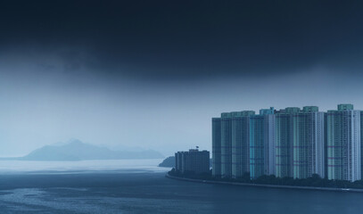 Seaside city under dark clouds