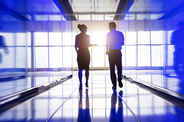 Business people walking and talking in the hallway