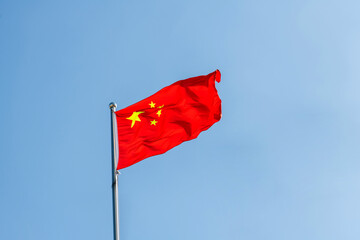 Chinese flag flying in the blue sky