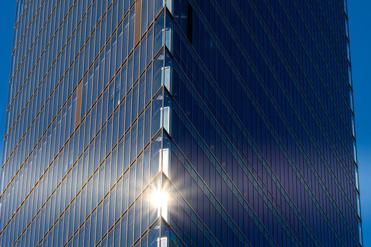 Modern abstract architecture skyscraper glass facade reflection lines in urban sunlight forming a clean geometric background for business