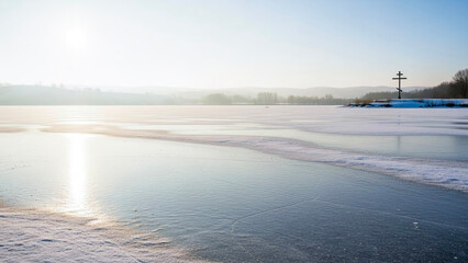 Winter landscape with frozen river reflecting sunlight at sunrise  