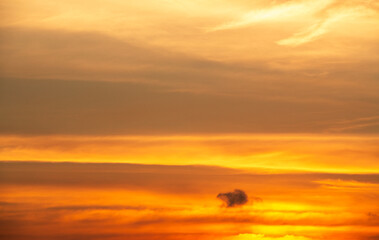 Beautiful bright orange sunset sky with clouds.