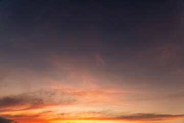 Fototapeta premium Beautiful bright orange sunset sky with clouds.