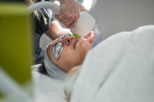 Woman receiving a laser skin care treatment in a beauty salon