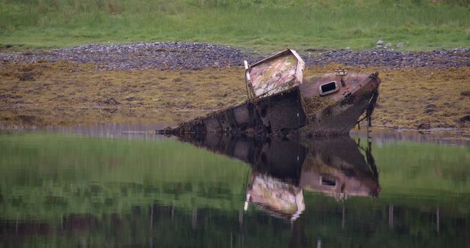 A wrecked fishing boat on the shores of Loch Etive showing the right starboard side at Eilean Traighe