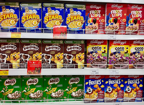 Da nang, Vietnam - December, 26, 2025: A supermarket shelf filled with various cereal boxes. Brightly colored packaging features popular brands like Kellogg's.