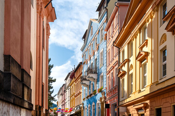 Colorful historic facades in a narrow alley with balconies and umbrellas in Děč&iacute;n old town, Czech Republic