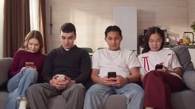 Sad ignore friends sit couch at home living room using smartphone. Addiction social media digital technology, people issue. Cell mobile phone scrolling problem. Useless cellphone internet surfing.