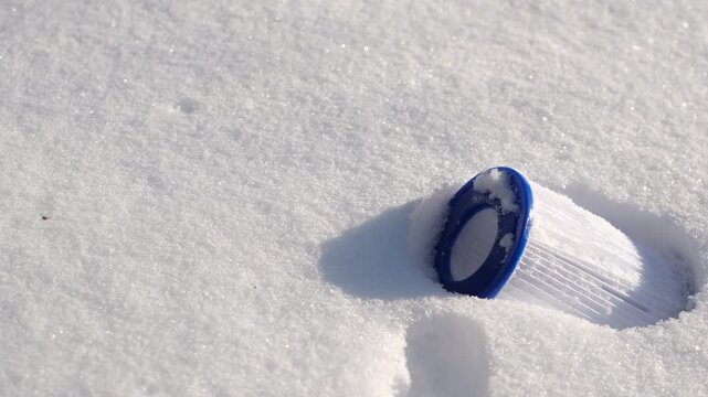 Replacement pool filter cartridge placed on clean white snow, symbolizing purity, cleanliness, and effective water filtration. Minimalistic outdoor composition. Copy space.