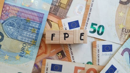 FPE acronym made of wooden letter cubes on pile of Euro banknotes. Fundo de Pensoes Empresarial (Corporate Pension Fund)