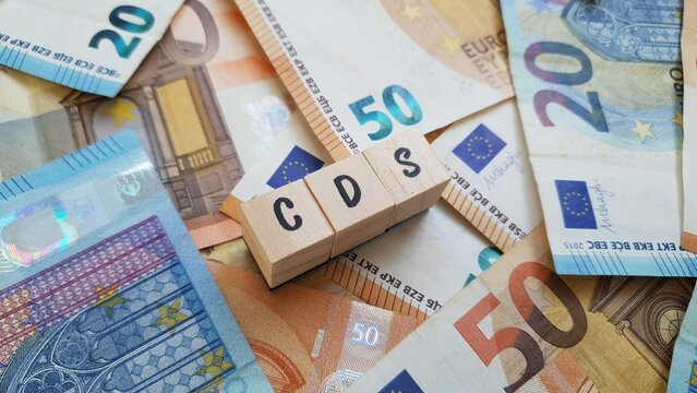 CDS acronym made of wooden letter cubes on pile of Euro banknotes.Caixa de Dep&oacute;sitos e Seguros (Deposits and Insurance Fund)
