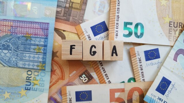 FGA acronym made of wooden letter cubes on pile of Euro banknotes. Fundo Geral de Aposenta&ccedil;oes (General Retirement Fund)
