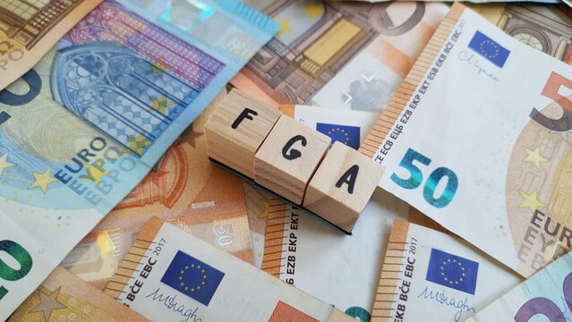FGA acronym made of wooden letter cubes on pile of Euro banknotes. Fundo Geral de Aposenta&ccedil;oes (General Retirement Fund)