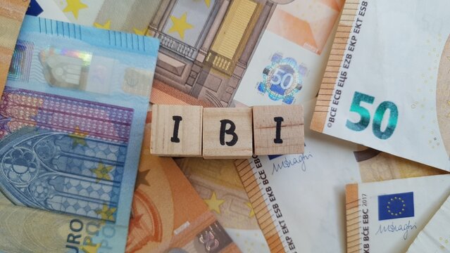 IBI acronym made of wooden letter cubes on pile of Euro banknotes. Imposto sobre a Propriedade Imobili&aacute;ria (Real Estate Property Tax)