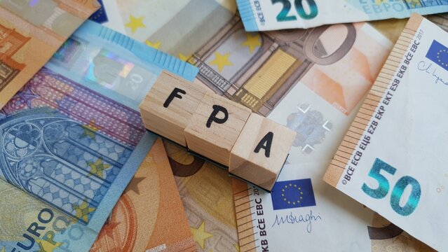 FPA acronym made of wooden letter cubes on pile of Euro banknotes. Fundo de Pensoes de Aposentadoria (Retirement Pension Fund)