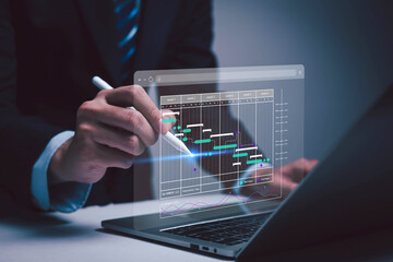 Person using laptop with digital calendar interface highlighting schedule dates. Concept of time management, business planning, productivity, deadline reminder, online scheduling, work organization. 