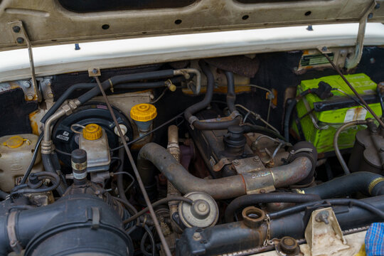 The engine of a vehicle is open and the hood is up