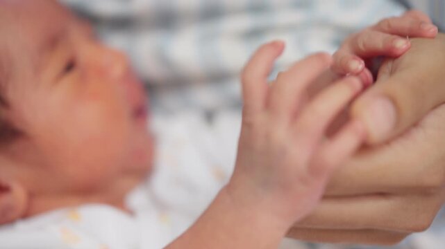 Close-up of newborn baby gently holding a parent s finger. Heartwarming symbol of love, trust, bonding, and early childhood care.