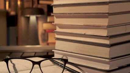 Books and Eyeglasses on Desk Representing Lifelong Learning and Education, Concept of continuous personal development, knowledge growth, and independent study environment - Powered by Adobe
