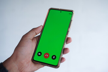 Man holding Smartphone with Green Screen Display for Application Mockups and Video Editing