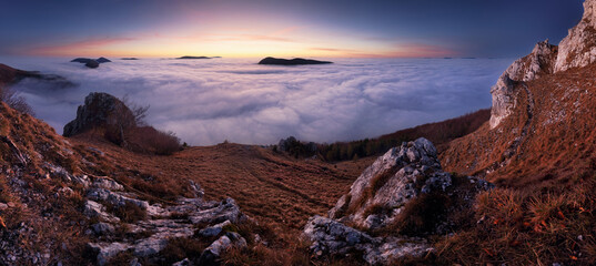Fototapeta premium Panorama of sunset in a Carpathian mountain valley with wonderful gold light on a hills