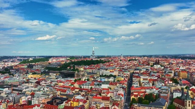Prague city across red rooftops. Prague urban pattern from above. Prague historic districts with modern landmarks. Prague capital of Czech.