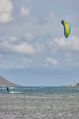 Mature man practicing kitesurfing. Aquatic sport. Athletic healthy senior