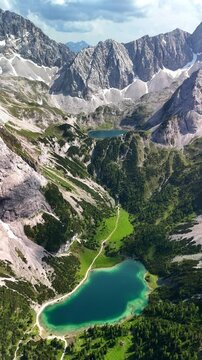 Vertical aerial drone view of the Alps and the green Drachensee and Seebensee on a sunny summer day.	
