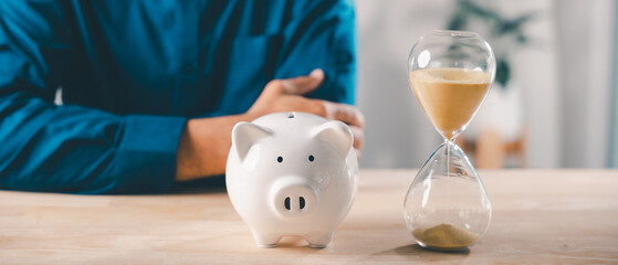 Hourglass and piggy bank for saving time and money help business save on cost, person managing company account and budget, focus on productivity with financial growth and success