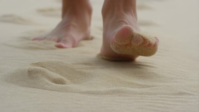 Barefoot walking through soft sand on a beach capturing relaxation and serenity