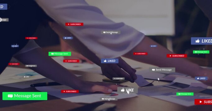 Animation of social media icons over mid section of colleagues discussing over documents at office
