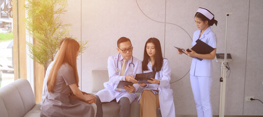 Male and female doctors are discussing checking a patient's temperature at the clinic.	