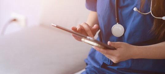 female doctors are discussing checking a patient's temperature at the clinic.	

